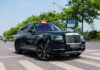 Close-up of Hanoi millionaire’s green Rolls-Royce Cullinan with illuminated logo