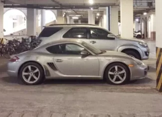 A Porsche Cayman Covered in Dust: A Sad Sight in an Underground Parking Lot of a Luxury Urban Area in Hanoi