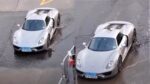 “Luxury Car Owner Carefully Navigates Porsche 918 Spyder Through Puddles”